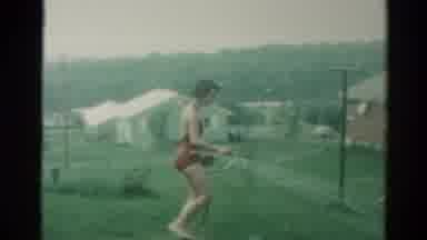 Catskill New York US (1962): Kids Playing In Yard Girl Spraying Boy With Sprinkler
