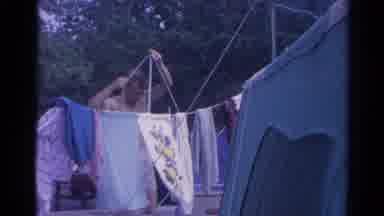 Catskill New York US (1962): Shirtless Man Setting Up Clothes Lines At A Campsite