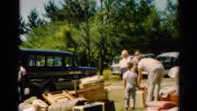 Catskill New York US (1962): People Around Vehicles With A Man Carrying A Suitcase