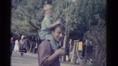 Catskill New York USA (1962): Children Riding On Men's Shoulders In A Park Setting