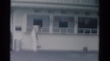 Catskill New York USA (1962): Man Wearing White Uniform Sweeps Outside Of White
