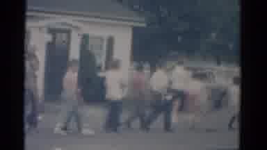 Catskill New York USA (1962): A Group Of People Are Walking Past A White Building