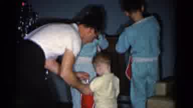 Catskill New York USA (1962): Man Wearing White Shirt Gives Red Stocking To Child