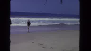 Los Angeles California USA (1962): Person Running Into Ocean From Beach