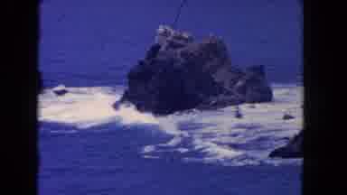 Los Angeles California USA (1962): Sea Waves Beating Rocks With Different Sizes