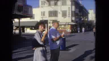 Los Angeles California USA (1962): Man And Woman Stand In The Middle Of A Walkway