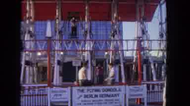 Los Angeles California USA (1962): Two People Riding A Fair Ride While Two Other