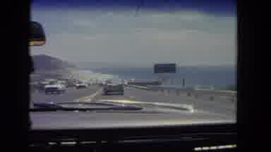 Los Angeles California USA (1962): Cars Driving Down The Highway During The Midday