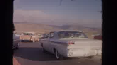 Los Angeles California USA (1962): Many Cars Travel Down Road In The Desert And A