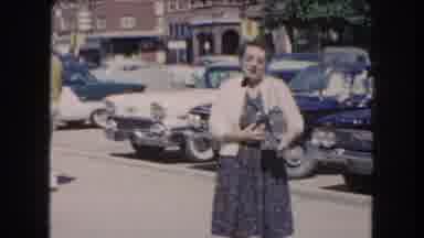 Summit County Colorado USA (1962): Old Woman Standing In A Parking Lot And Waving