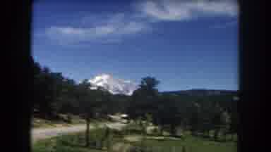 Summit County Colorado USA (1962): A Forest And Mountain Is Videoed From A Moving