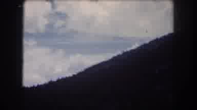 Summit County Colorado USA (1962): The Clouds Erupt From Behind The Bluff In
