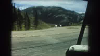 Summit County Colorado USA (1962): Cars Driving On A Large Dirt Road Next To A