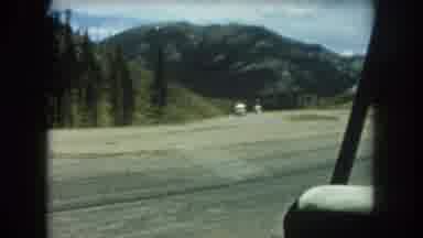 Summit County Colorado USA (1962): Four People Walking In Grass Near Dense Forest