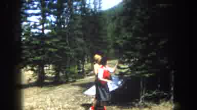 Summit County Colorado USA (1962): Two Women Walking Slowly Through A Forest And