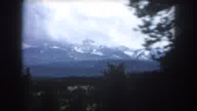 Summit County Colorado USA (1962): Driving Along A Road With Trees And A Large