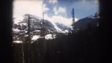 Summit County Colorado USA (1962): Green Trees In Front Of Snowy Mountains