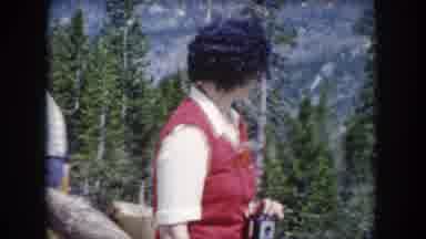 Summit County Colorado USA (1962): A Woman In Red Clothes Looks At Something And