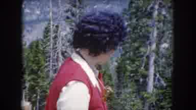 Summit County Colorado USA (1962): Woman Pointing Out A Chipmunk Who Is Eating On