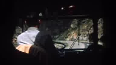 Summit County Colorado USA (1962): A Man Is Driving The Vehicle In The Narrow Road