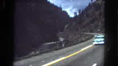 Summit County Colorado USA (1962): A Person Driving Down The Street Surrounded By