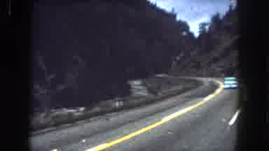 Summit County Colorado USA (1962): Driving Around A Mountain Road With River On