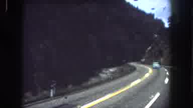 Summit County Colorado USA (1962): People Driving Down A Mountain Terrain With A