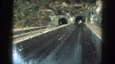 Summit County Colorado USA (1962): Vehicle On Highway Driving Through A Tunnel In