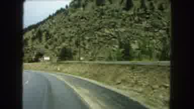 Summit County Colorado USA (1962): Car Driving Down The Freeway With Hills In The