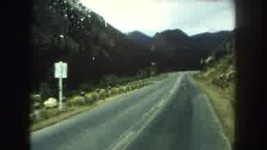 Summit County Colorado USA (1962): Riding Down A Two Lane Road With A Mountain