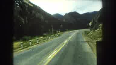 Summit County Colorado USA (1962): Car Driving Slowly Through Mountains Passes