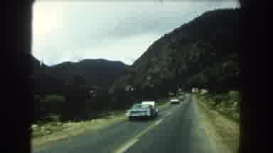 Summit County Colorado USA (1962): Through A Hilly Highway A Lot Of Vehicles Are