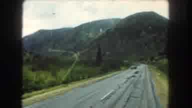 Summit County Colorado USA (1962): Traveling Along Two Lane Road Through Hills And