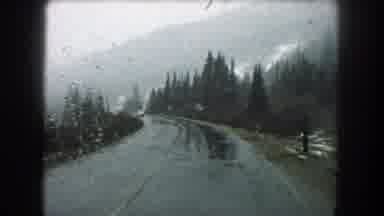 Summit County Colorado USA (1962): Snow Falling Over A House And A Car Riding On