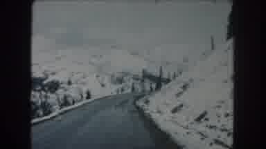 Summit County Colorado USA (1962): Driving On A Curvy Snowy Mountain Side In The