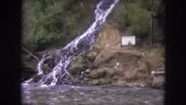 Winter Park Colorado USA (1962): Fast Moving River Runs Past A Waterfall Showing A