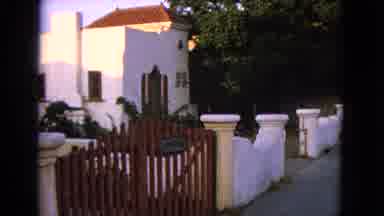 Barrington Illinois USA (1963): Two Boys Running Past White Fence On A Clear Day