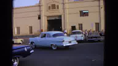 Barrington Illinois USA (1963): Cars Driving In A White 1950s Town Going By A