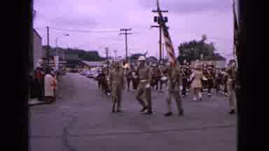 Barrington Illinois USA (1963): Marching Band Follows Military Men In Parade Down