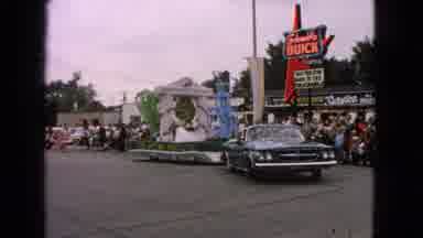 Barrington Illinois USA (1963): Parade Float Passes Buick Dealership