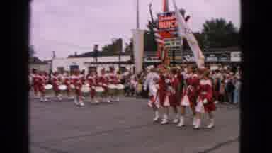 Barrington Illinois USA (1963): Marching Band In Red Uniforms Rounding The Corner