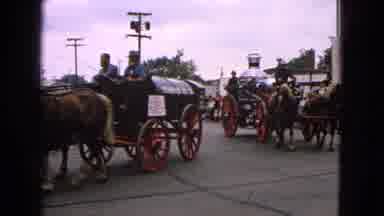 BARRINGTON ILLINOIS USA-1963: Firemen On Horse And Buggy Carriages Pass Many