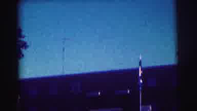 Bowling Green University USA (1963): A Flagpole And Flag Sit In Front Of A