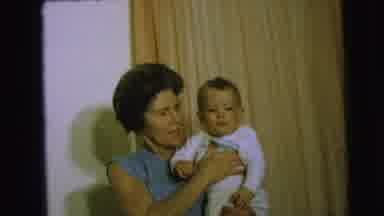 Camden New Jersey (1963): Elderly Woman Holds Baby As She Talks In Front Of White