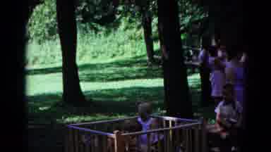 Cold Springs New York USA (1963): Two Babies Playing In A Safe Area And A Party