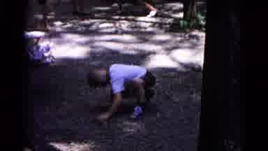 Cold Springs New York USA (1963): Boy Digs Hole While Grandparents Look On In
