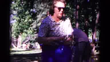 Cold Springs New York USA (1963): Older Woman Blowing Up And Tying A Large Blue