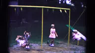 Cold Springs New York USA (1963): Children In Shorts And Dresses Play On Swings At