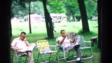 Cold Springs New York USA (1963): Two Men Sit Outside And Read The Newspaper While