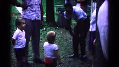 Cold Springs New York USA (1963): Boy Wearing White Shirt With Red Pants Talks To